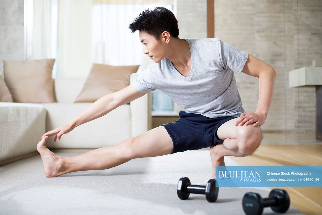 Young Chinese man exercising at home