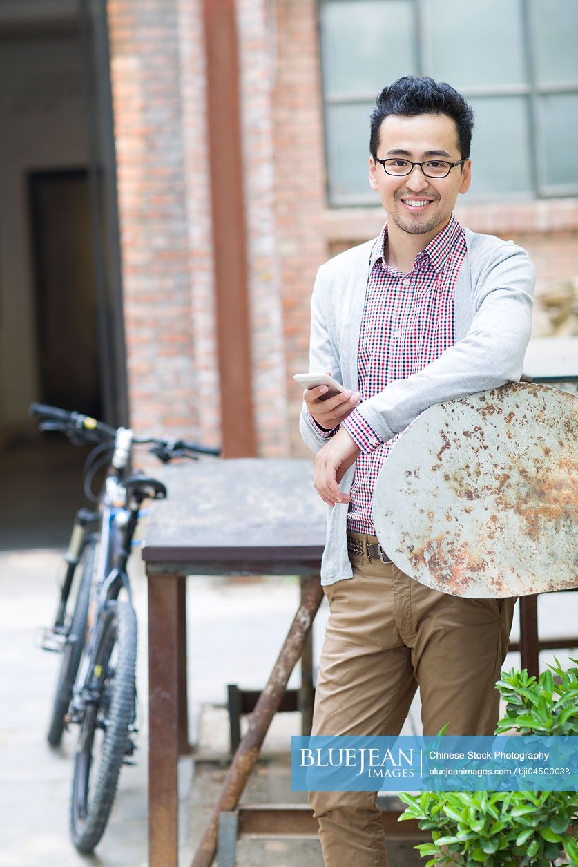 Chinese man holding a smart phone