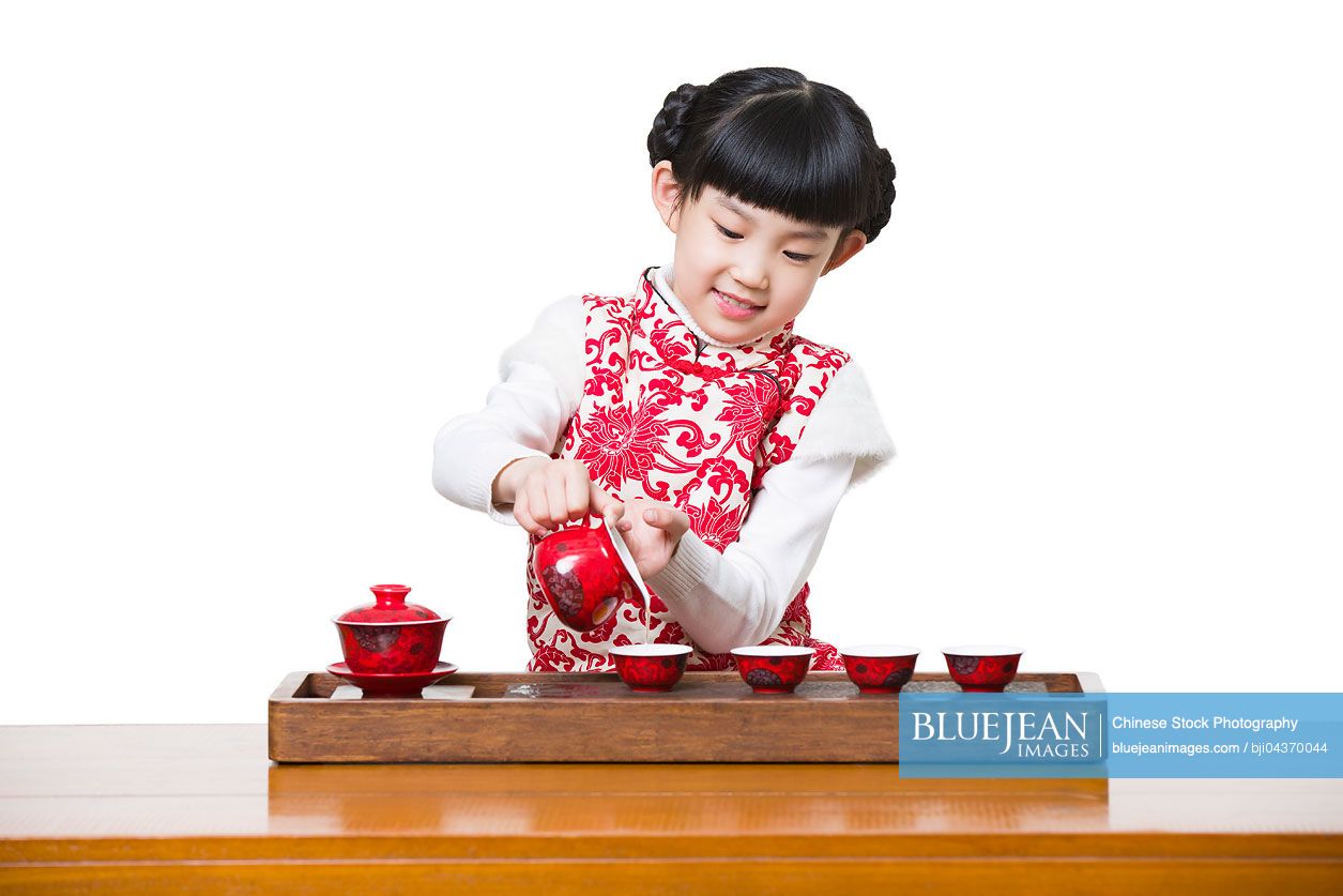 Happy Chinese girl performing tea ceremony