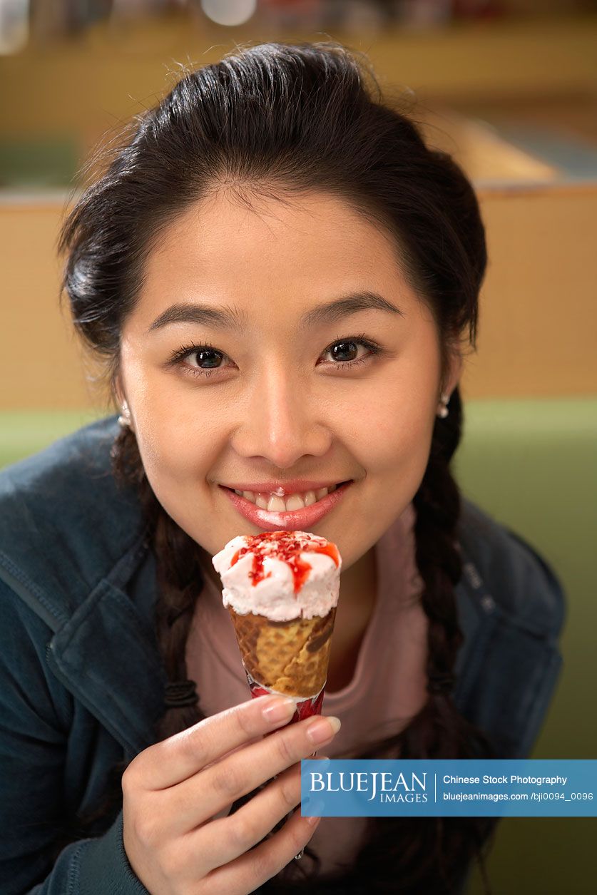 Chinese teenage girl eating ice cream