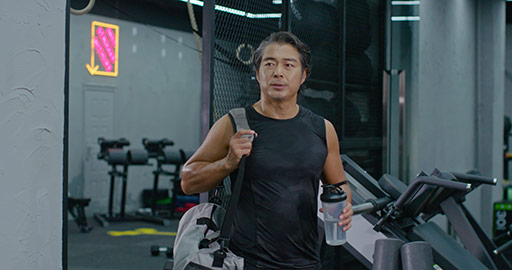 Mature Chinese man with gym bag at gym,4K