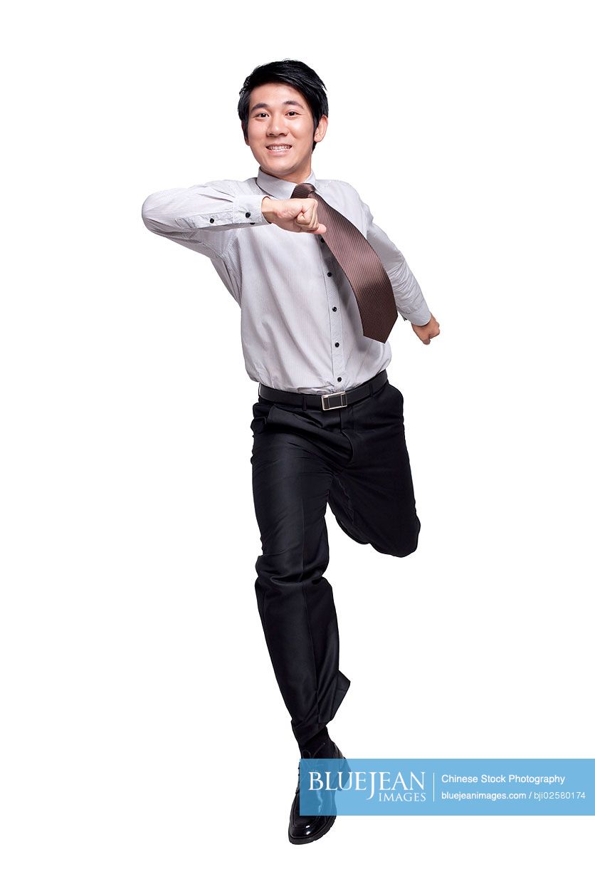 Excited Chinese businessman jumping in the air