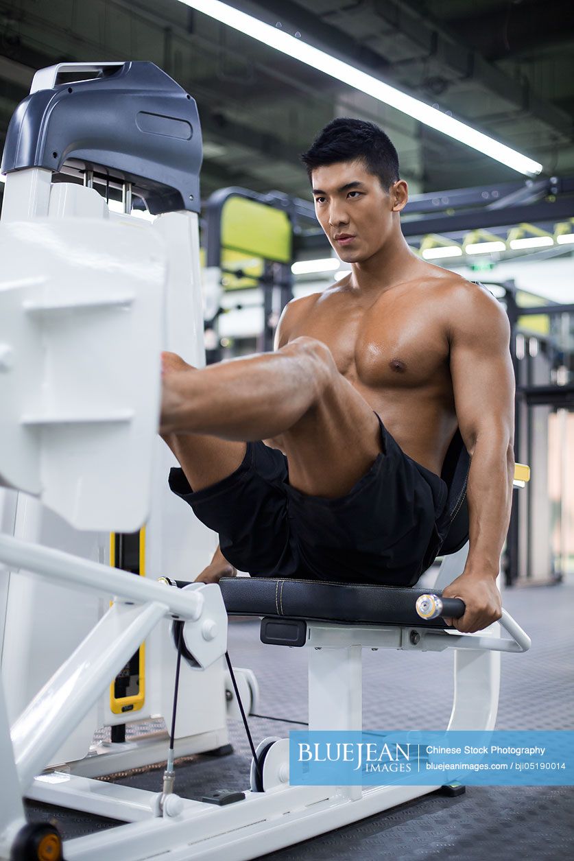 Young Chinese man exercising at gym