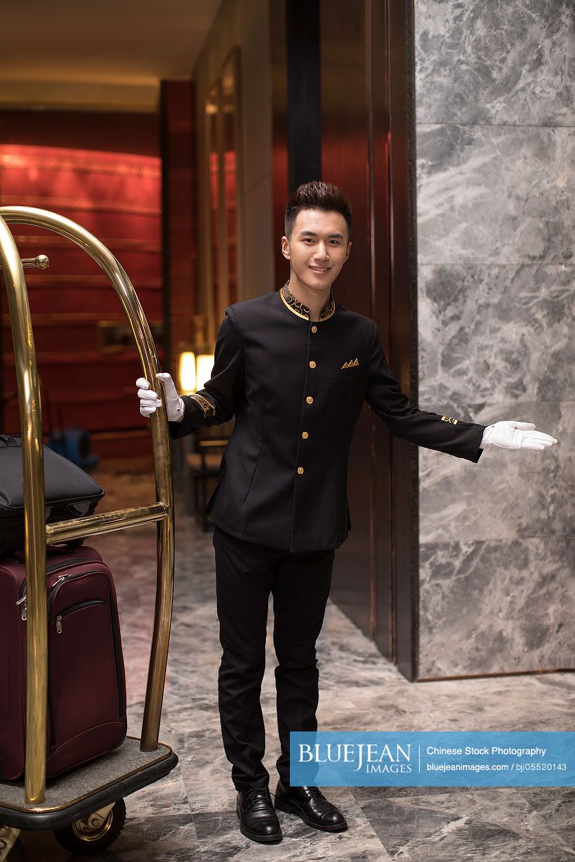 Cheerful Chinese bell boy greeting