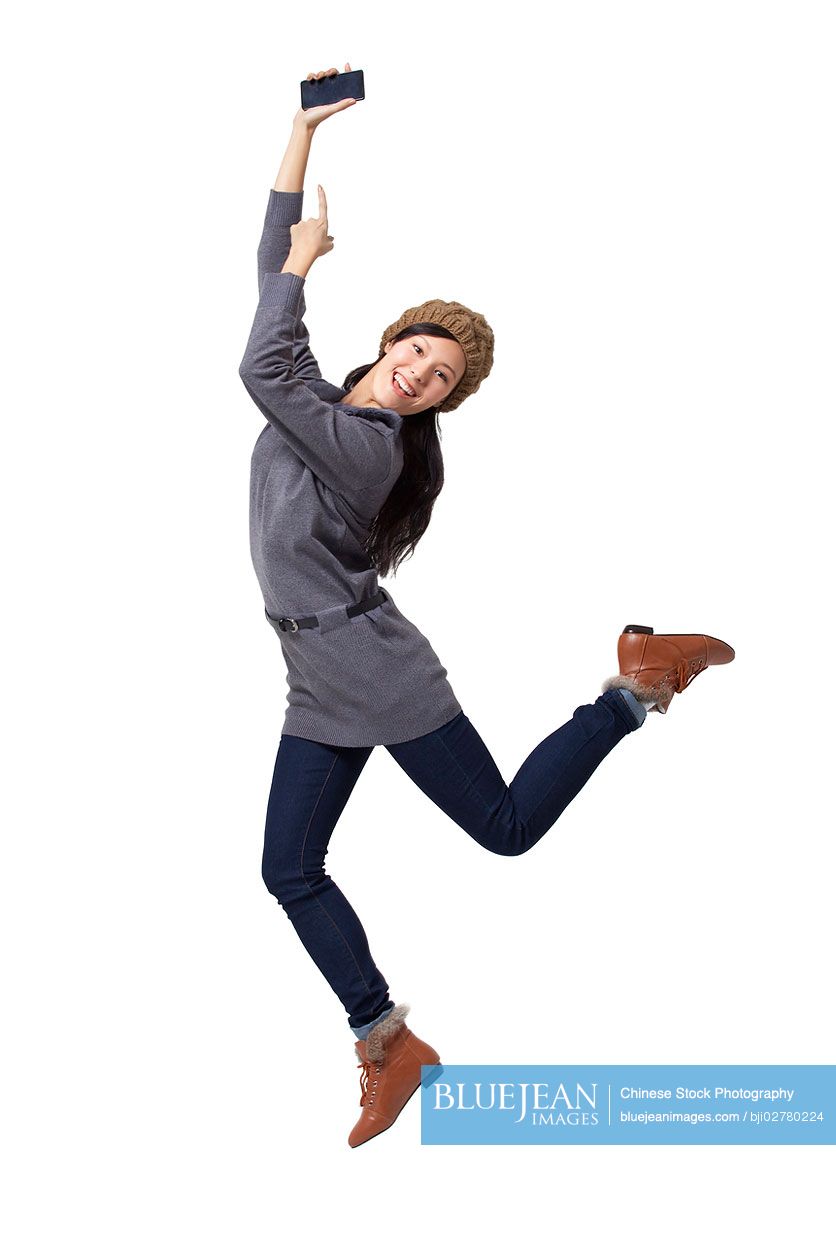 Young Chinese woman showing mobile phone