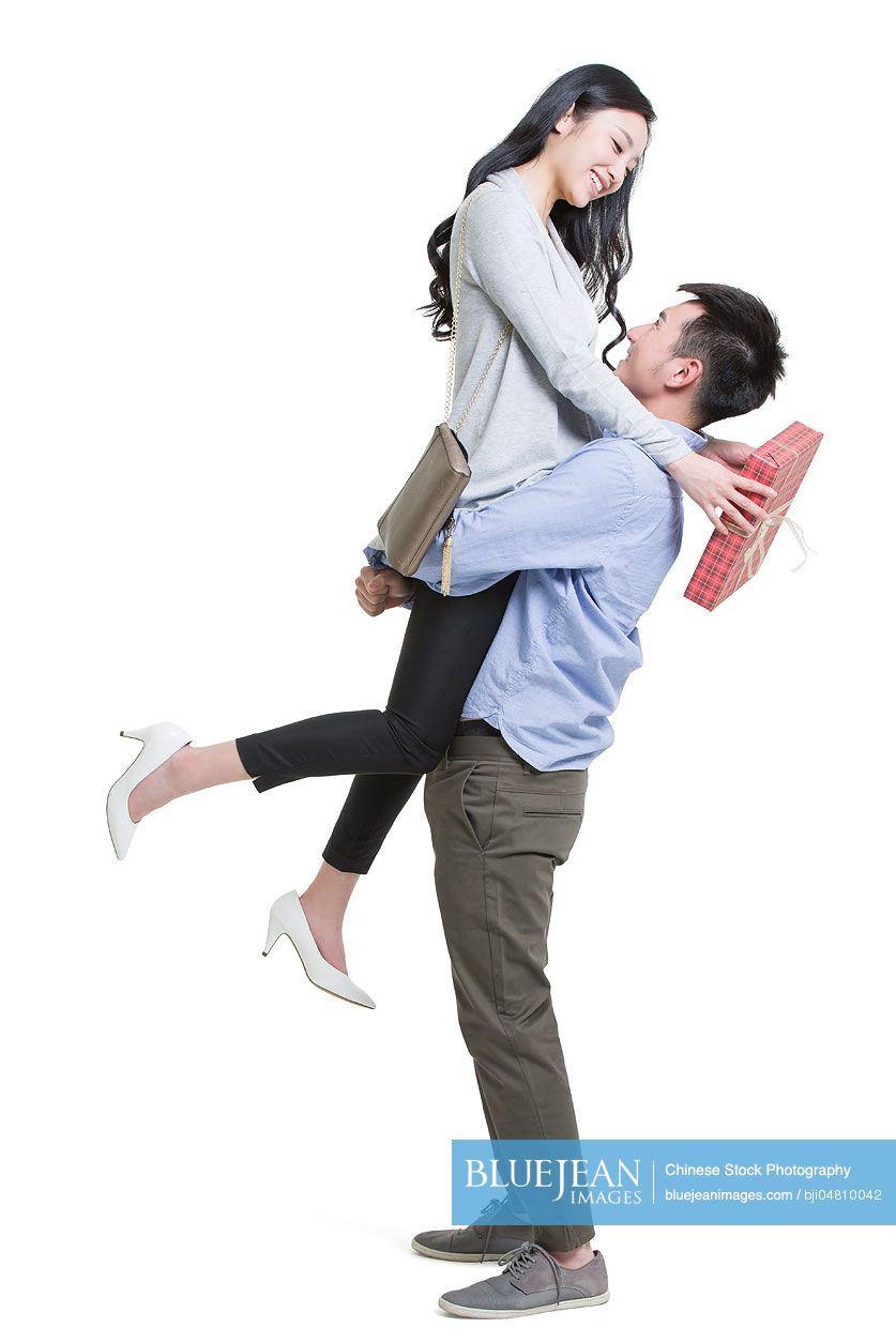 Young Chinese man giving gift to girlfriend