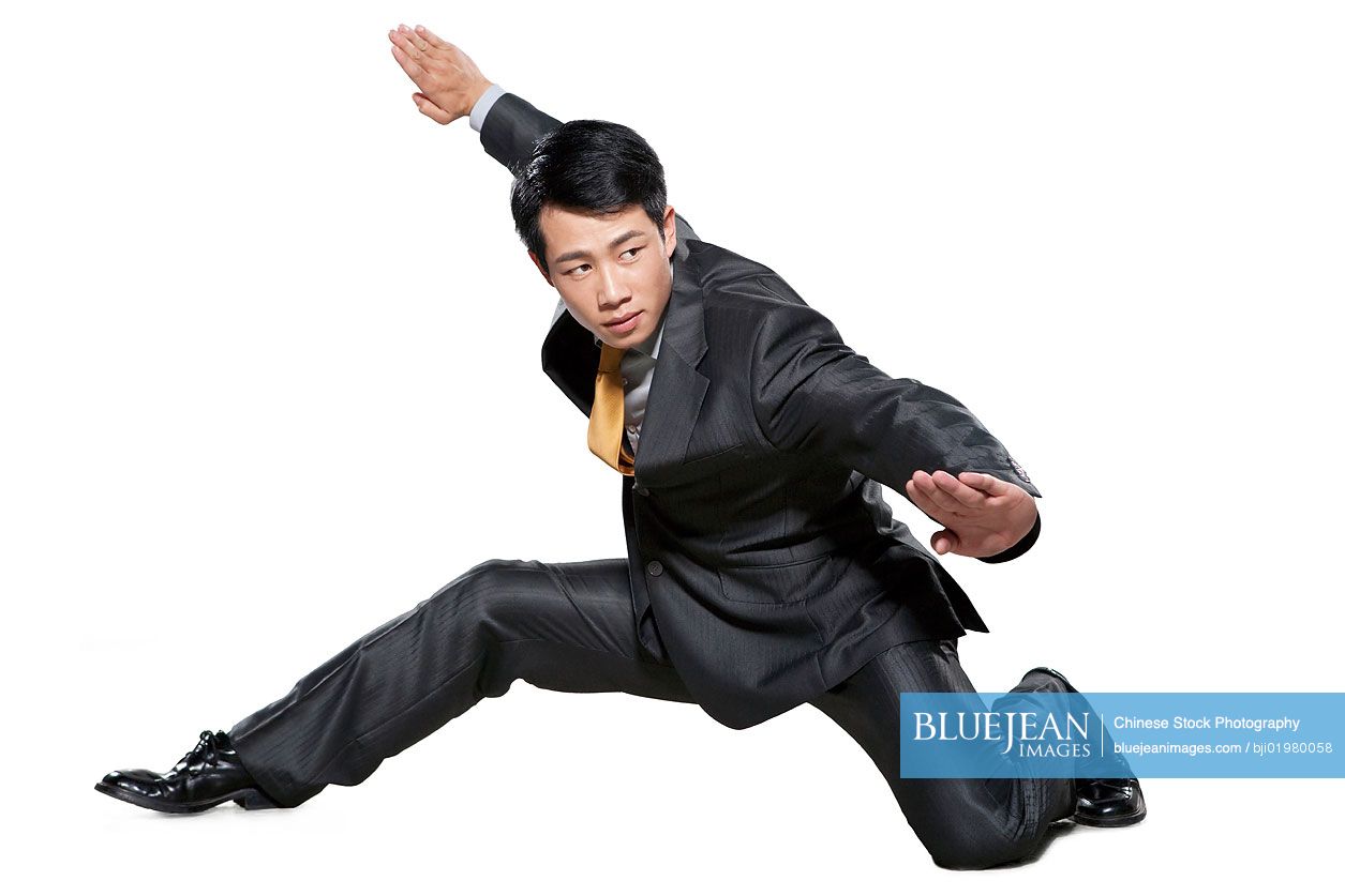 Chinese businessman in martial arts crouching stance