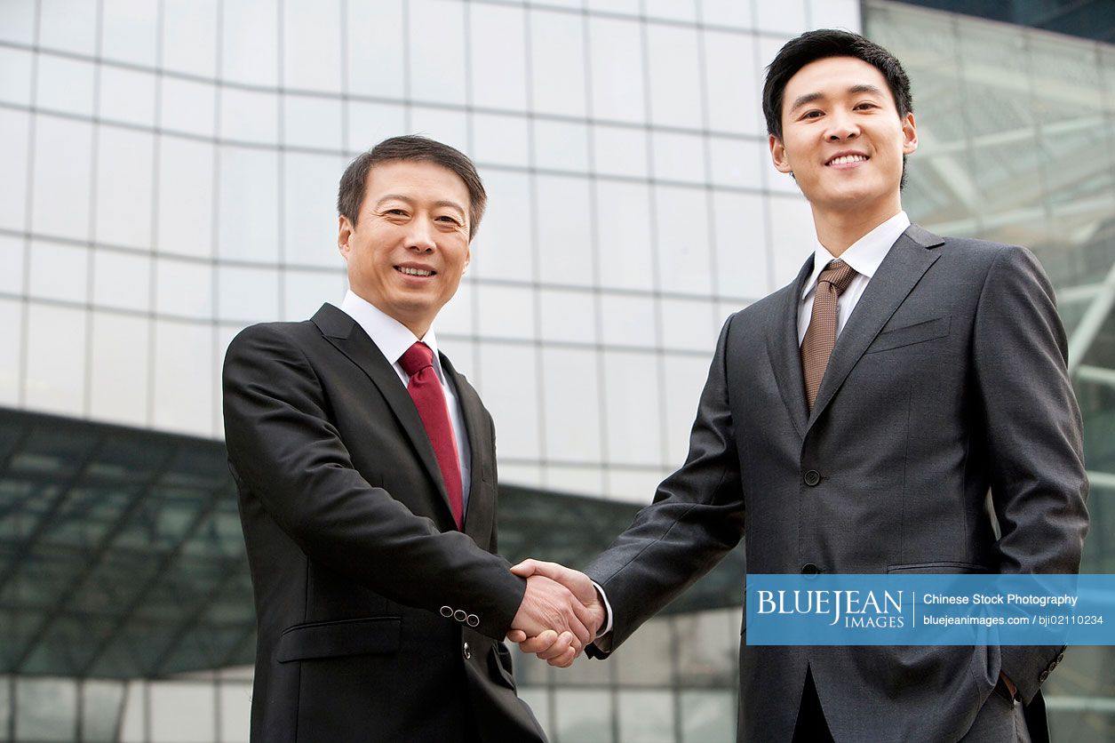 Chinese businessmen shaking hands