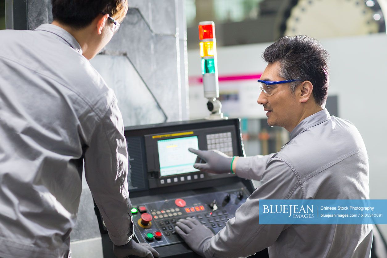 Confident Chinese engineers working in the factory