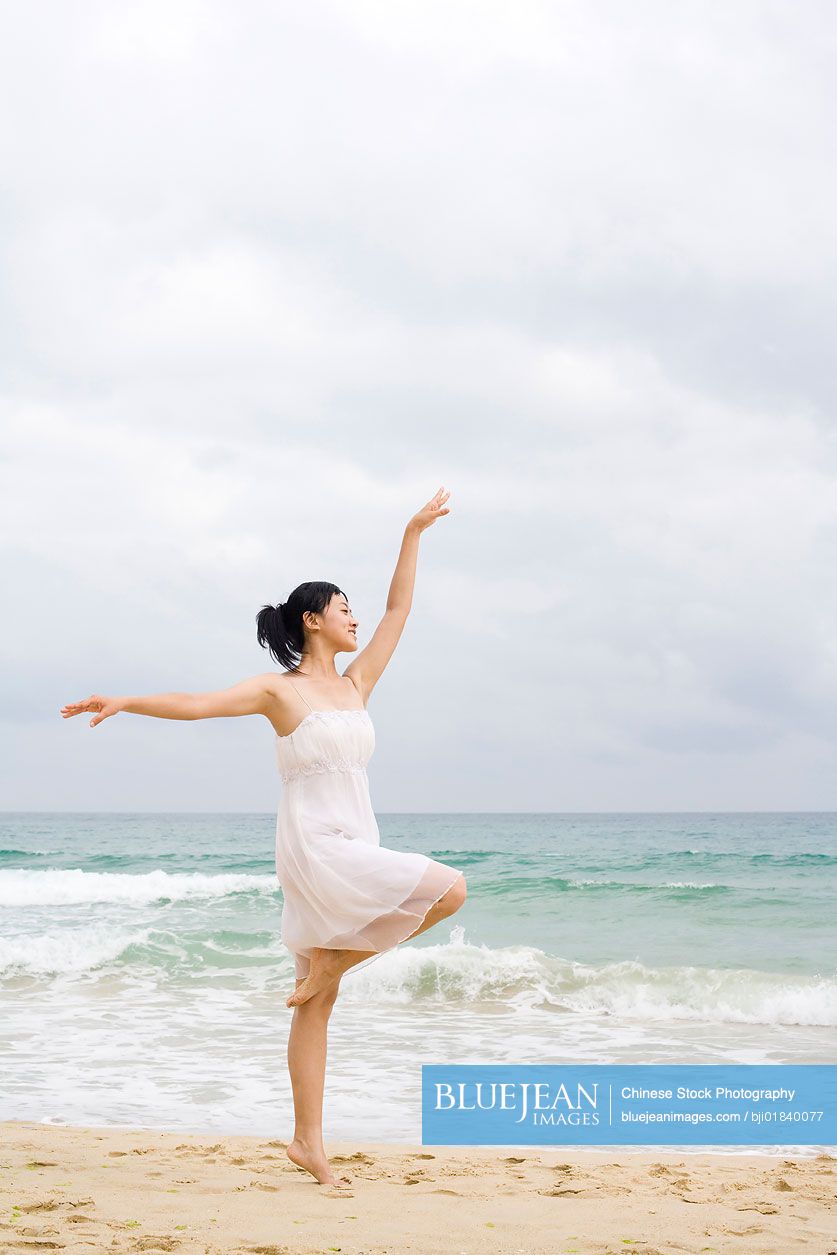 A woman dancing at the beach