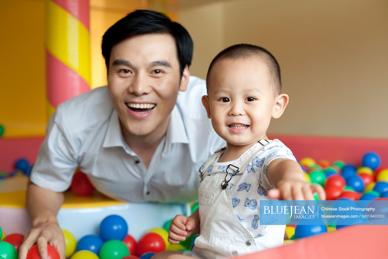 Chinese father playing with son