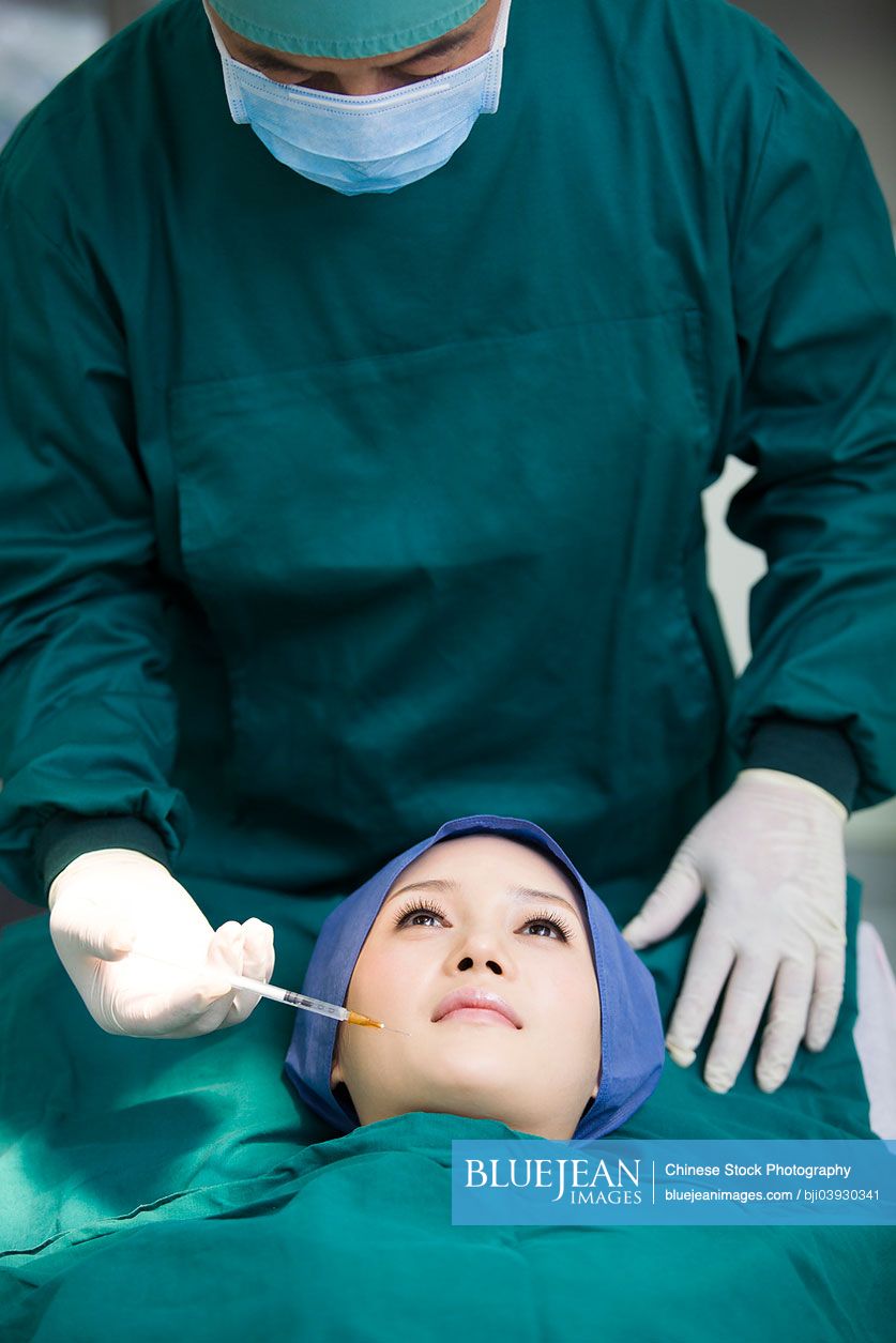 Chinese patient on operating table receiving plastic surgery