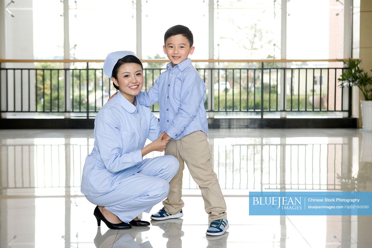 Chinese nurse and young boy in a hospital corridor