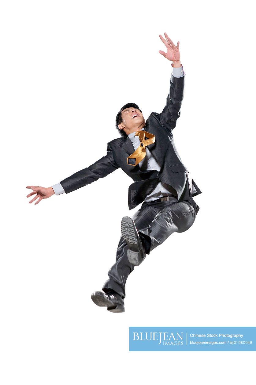 Chinese businessman jumping in the air