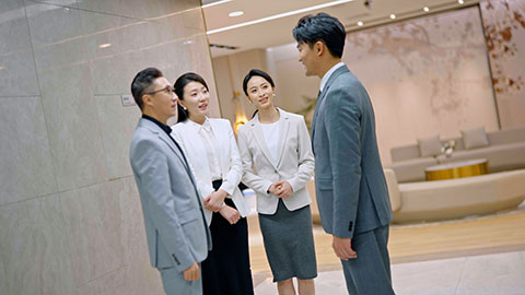 Successful Chinese business people shaking hands in office