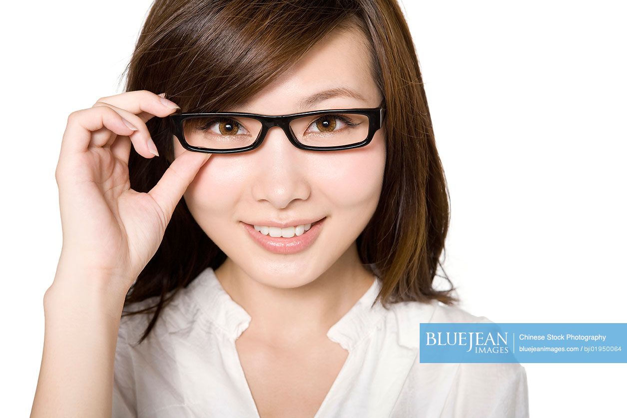 Portrait of young Chinese woman hand to glasses