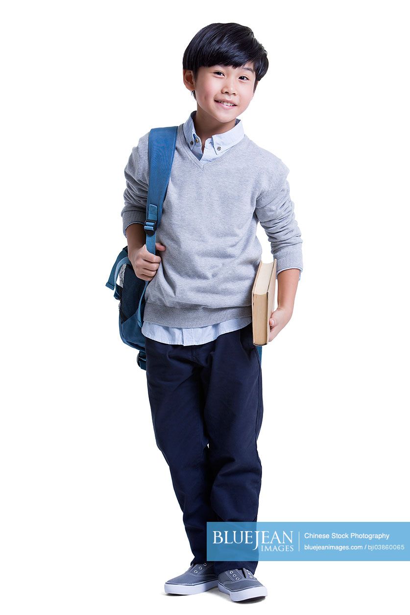 Cute Chinese schoolboy with book in hand