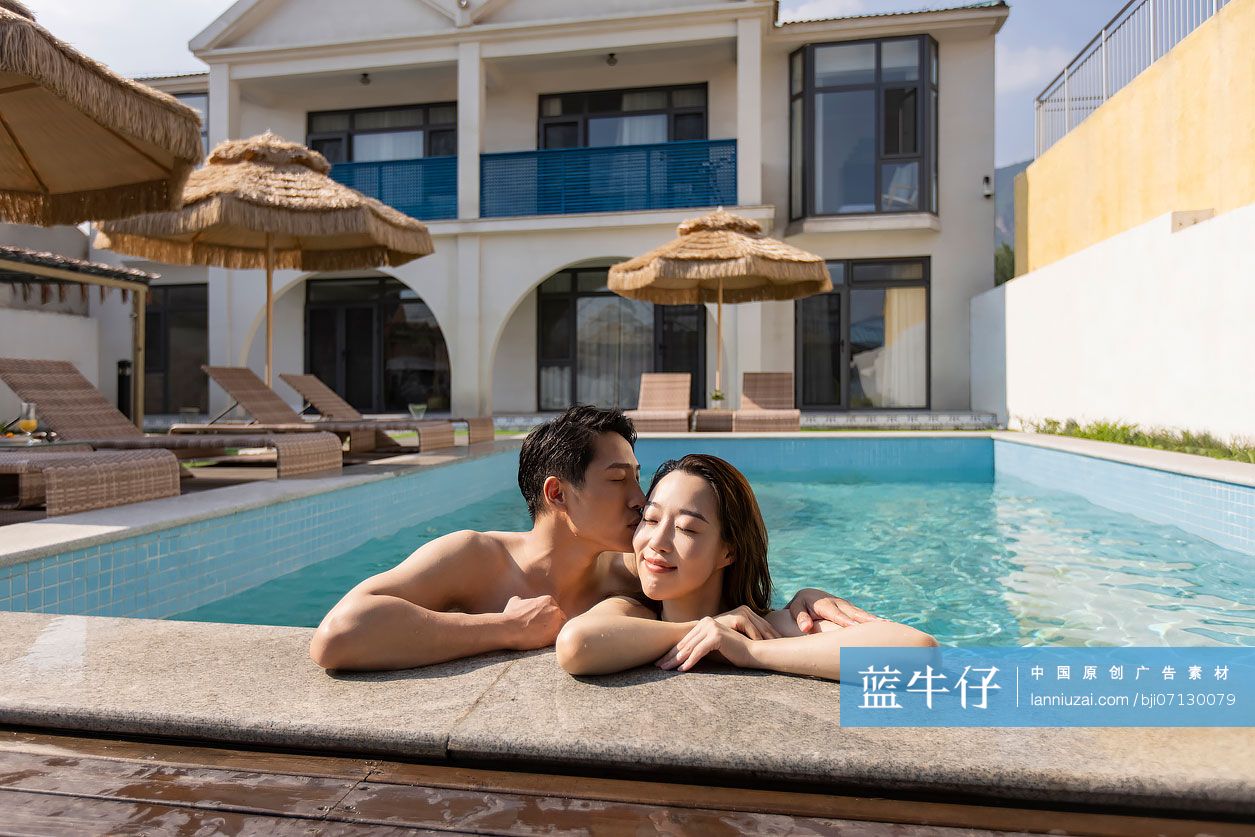 快乐的年轻情侣趴在泳池边