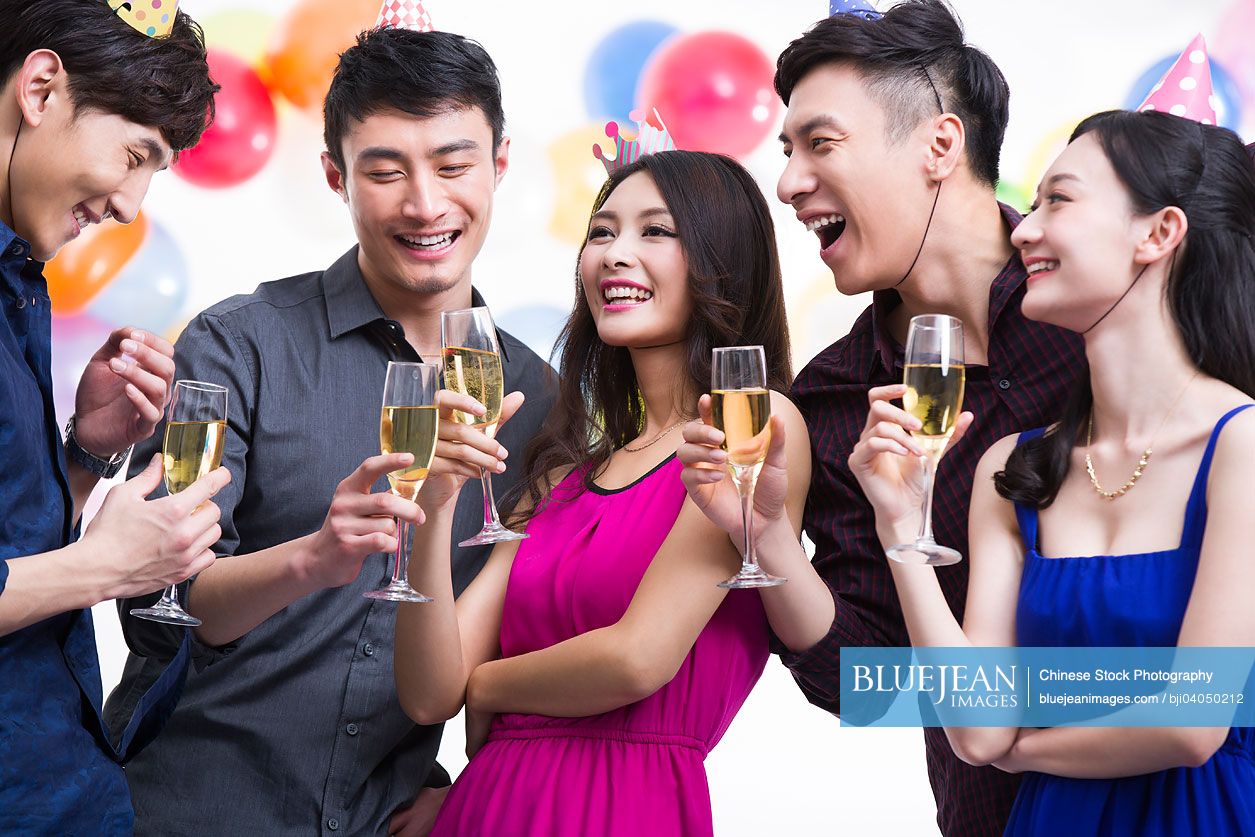 Young Chinese adults toasting in party