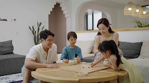 Family enjoying a game of Go in the hotel room