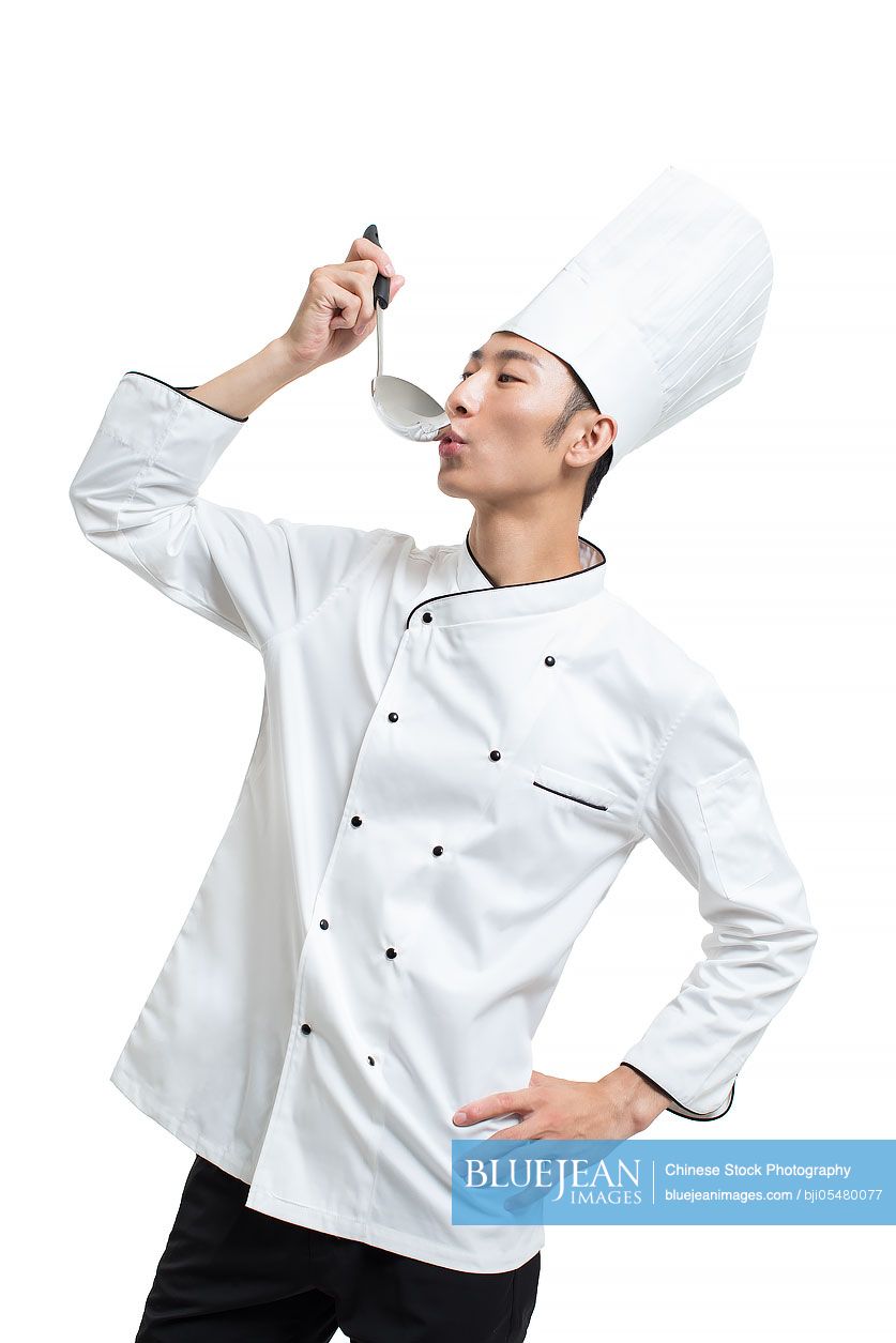 Cheerful Chinese chef holding a ladle