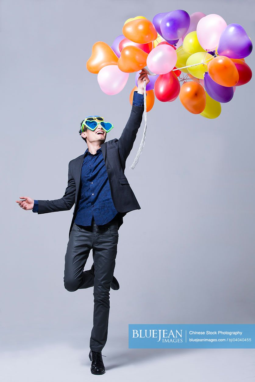 Hip young Chinese man with balloons