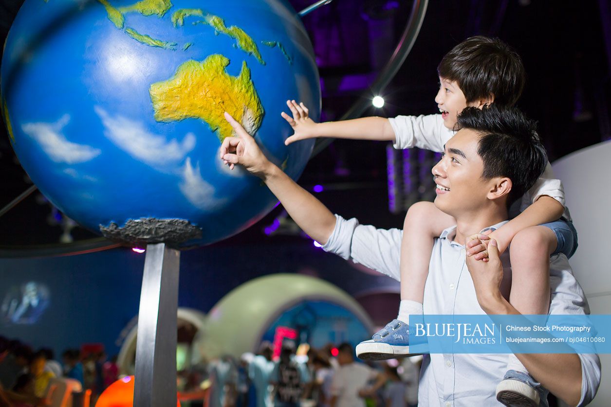 Young Chinese father and son in science and technology museum