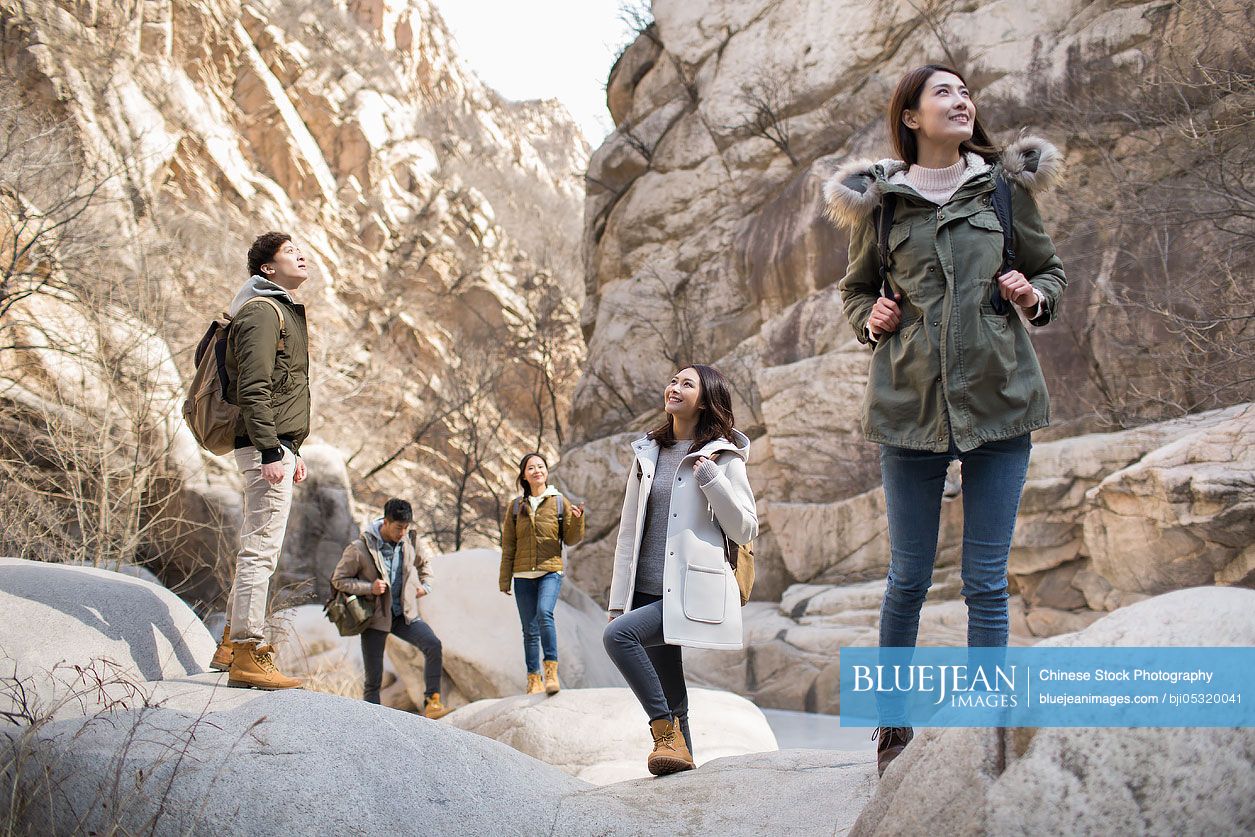 Happy young Chinese friends enjoying winter outing