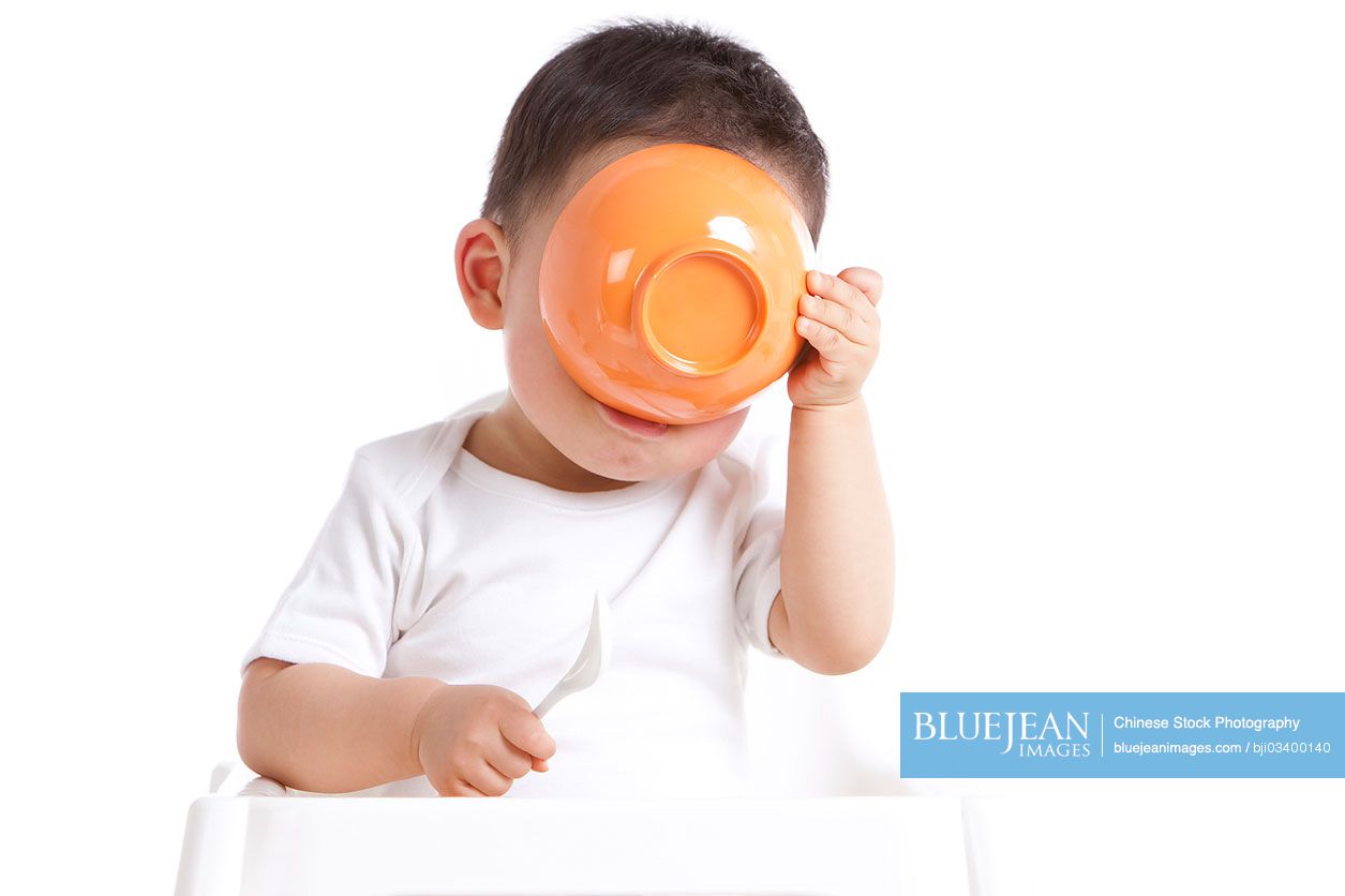 Chinese baby boy with spoon and bowl