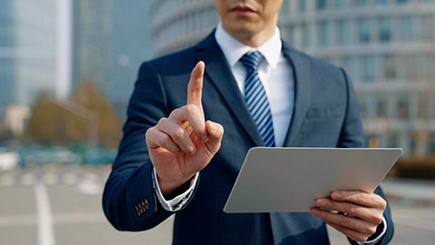 Confident Chinese businessman using digital tablet