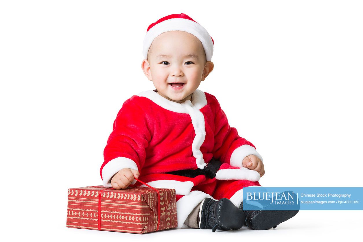 Chinese baby holding Christmas gift