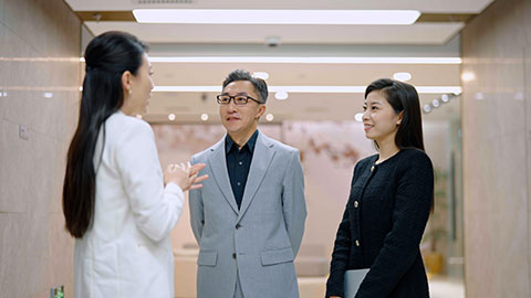 Confident Chinese business people talking in office