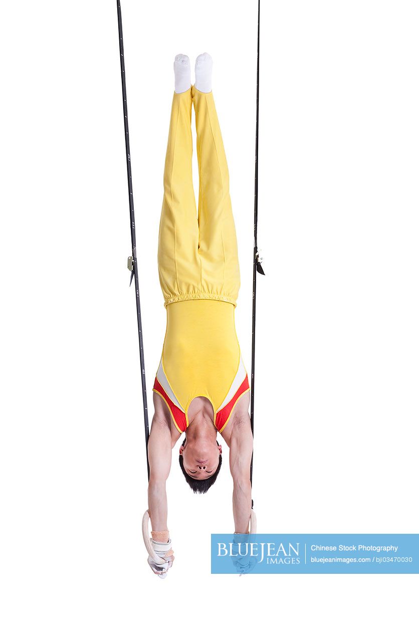 Chinese gymnastic athlete upside down on the rings