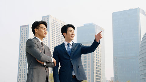 Confident Chinese business people talking outdoors