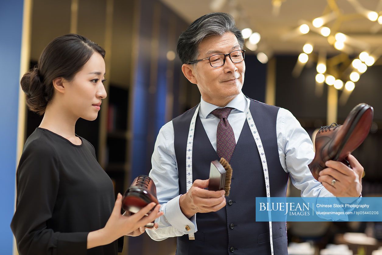 Chinese fashion designers polishing leather shoes