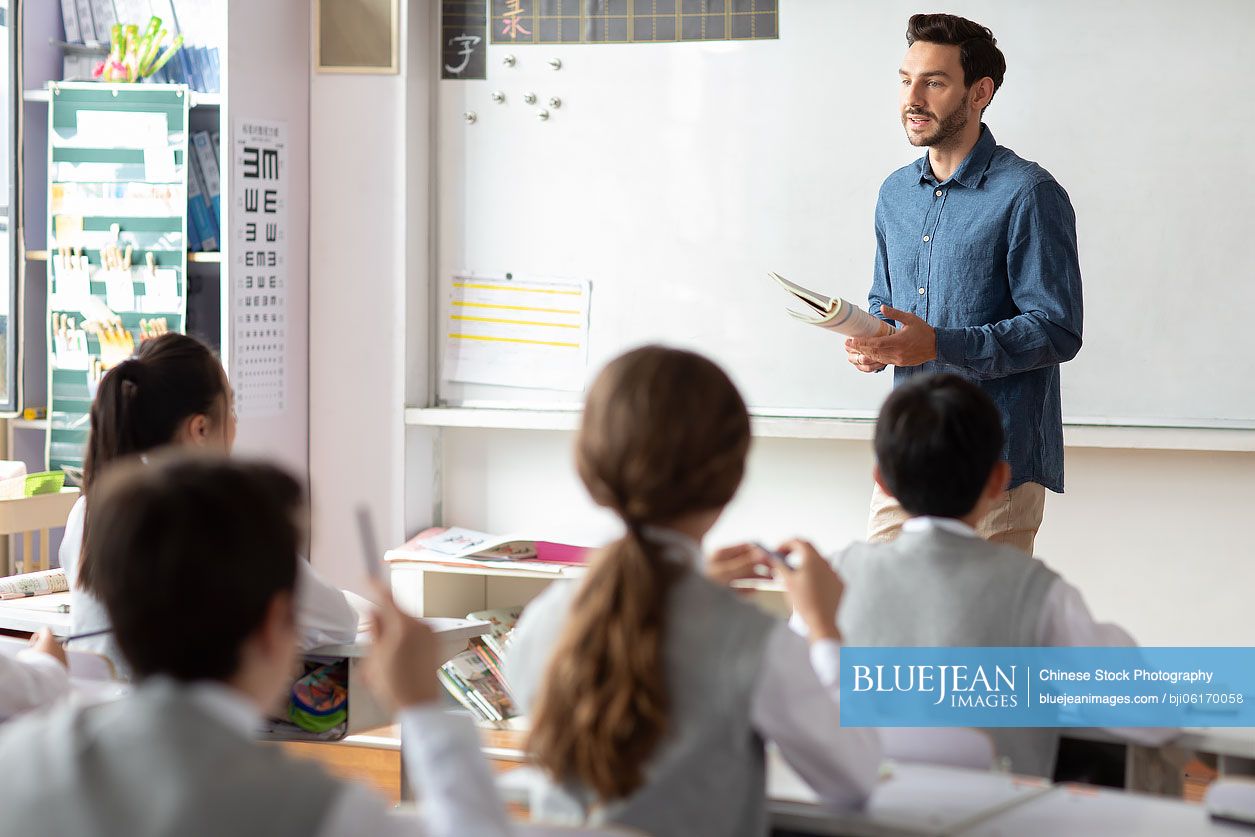 Young Chinese teacher teaching a class