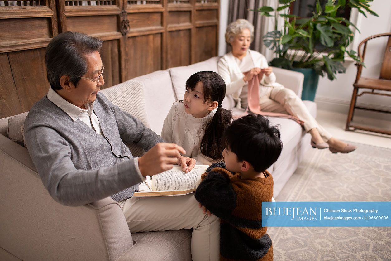 Chinese grandpa telling story to grandchildren