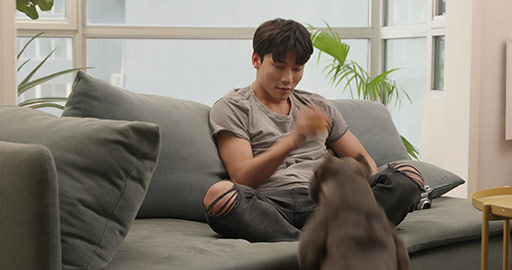 Young Chinese man playing with pet dog at home,4K