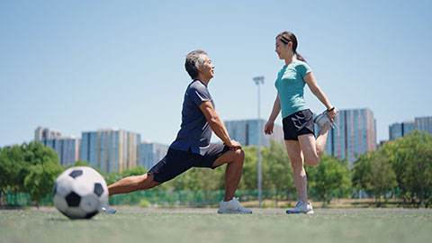 Happy Chinese couple playing football