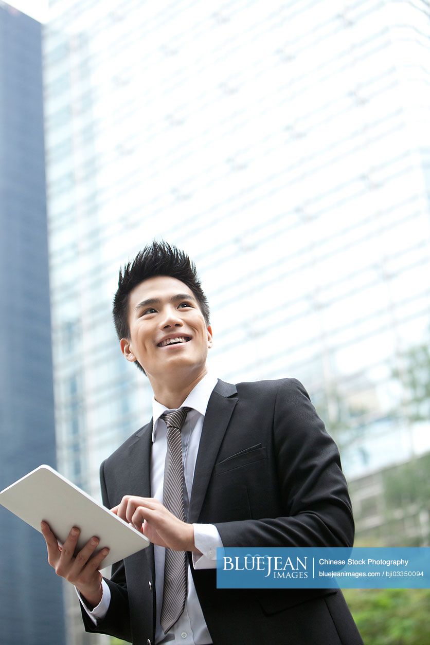 Professional Chinese businessman with digital tablet, Hong Kong