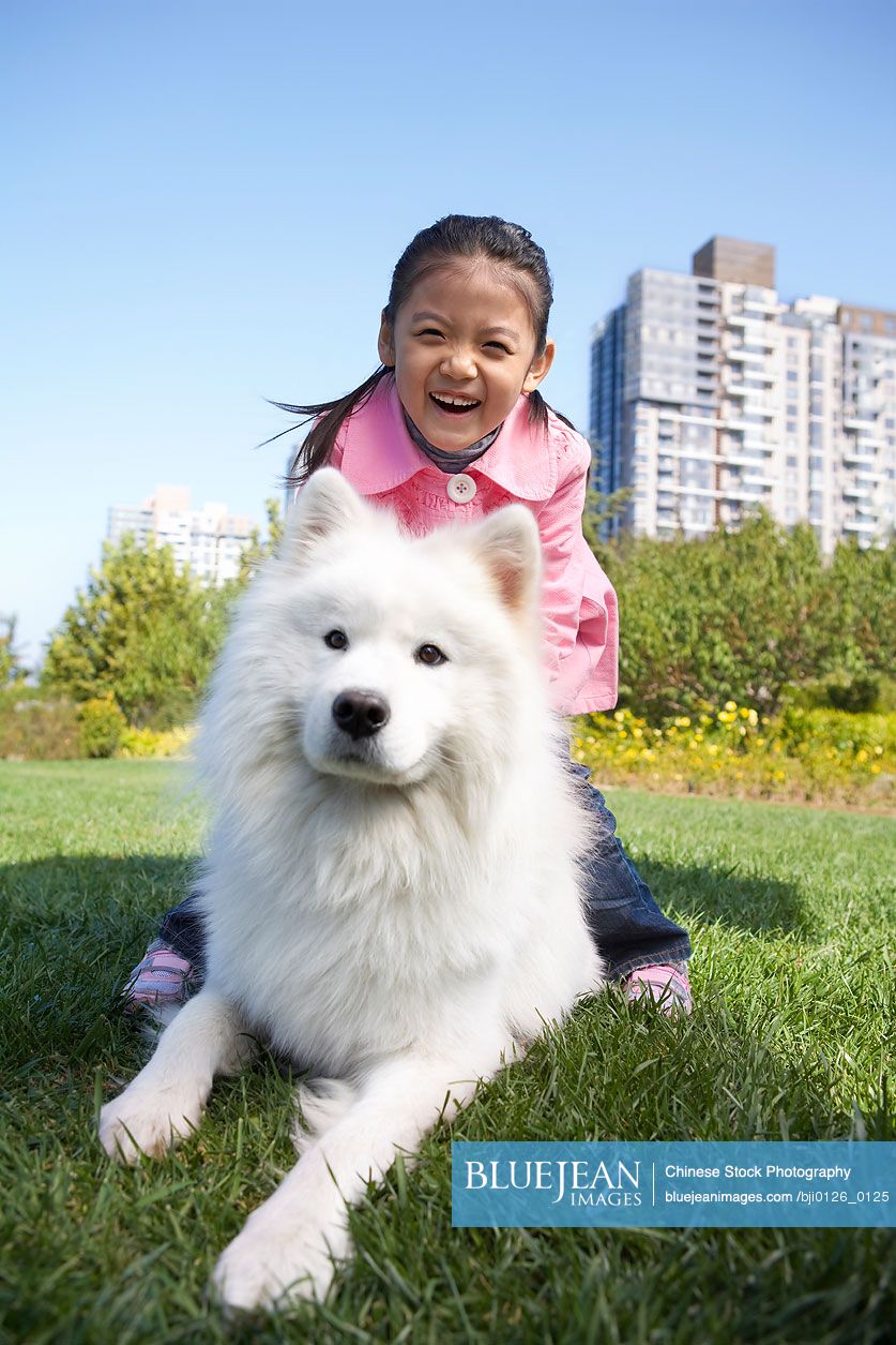 Young Chinese girl and her dog