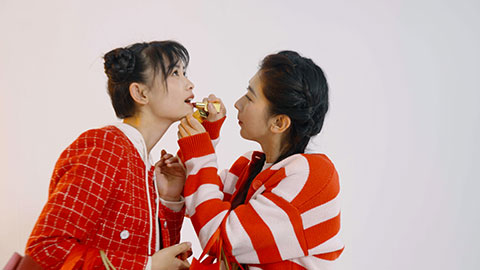 Best female Chinese friends applying make-up