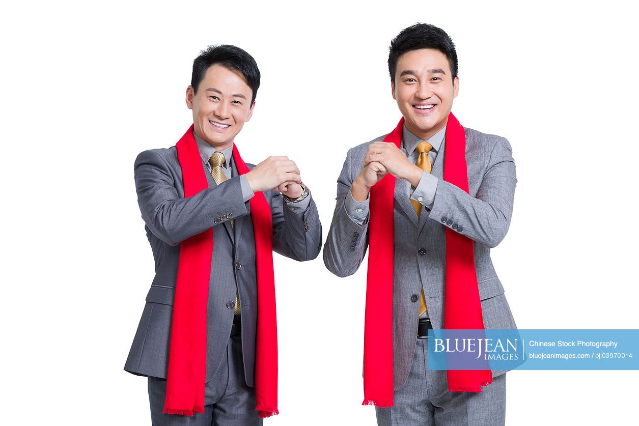 Chinese businessmen offering traditional Chinese New Year greeting