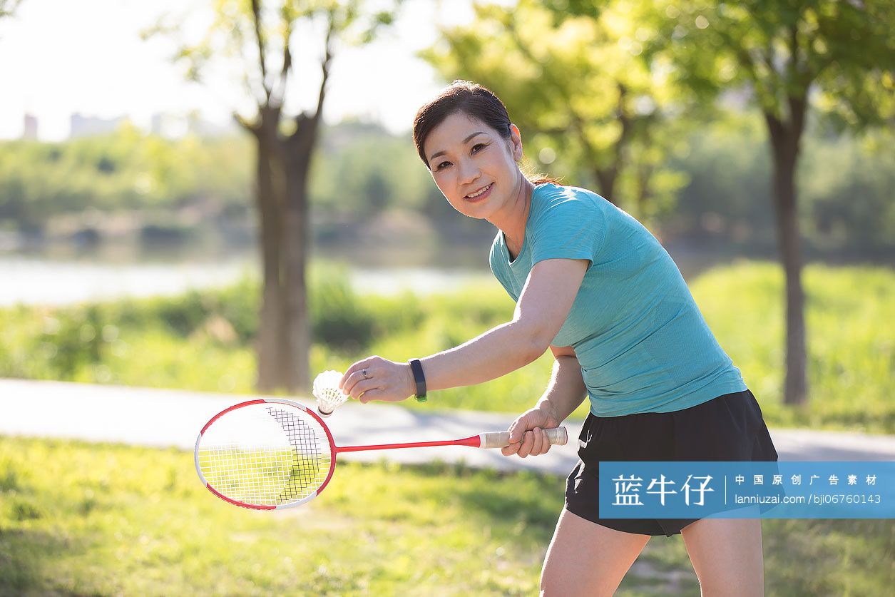 开心的中老年女子在户外打羽毛球