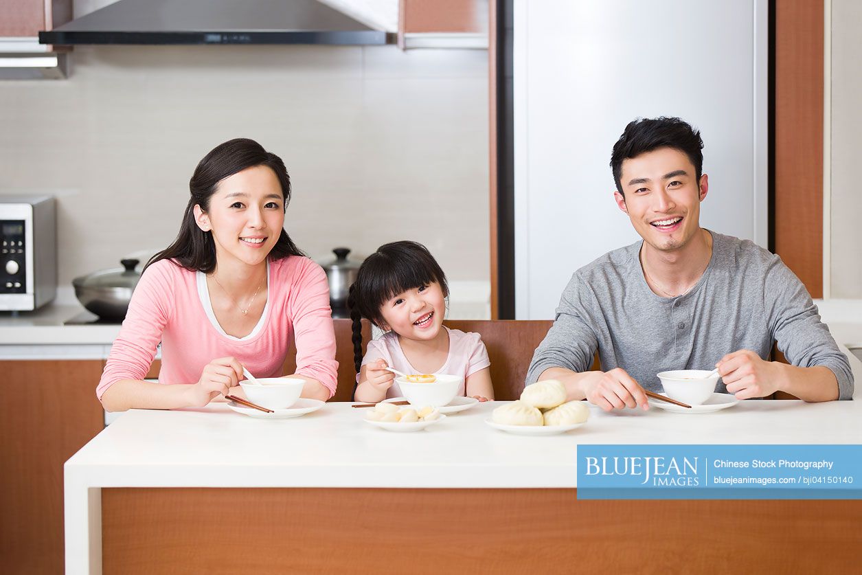 Happy Chinese family having breakfast