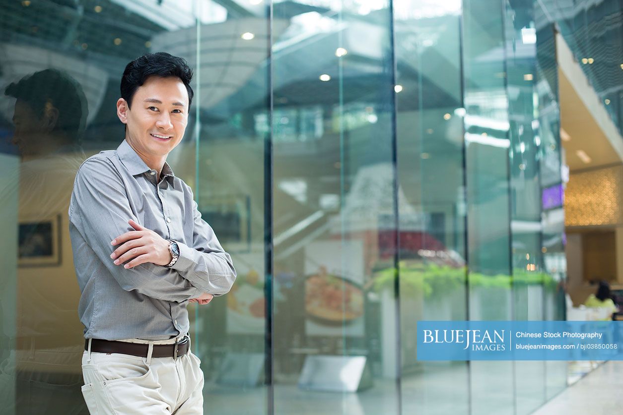 Portrait of Chinese man hands arms crossed