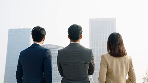 Confident Chinese business people looking at view