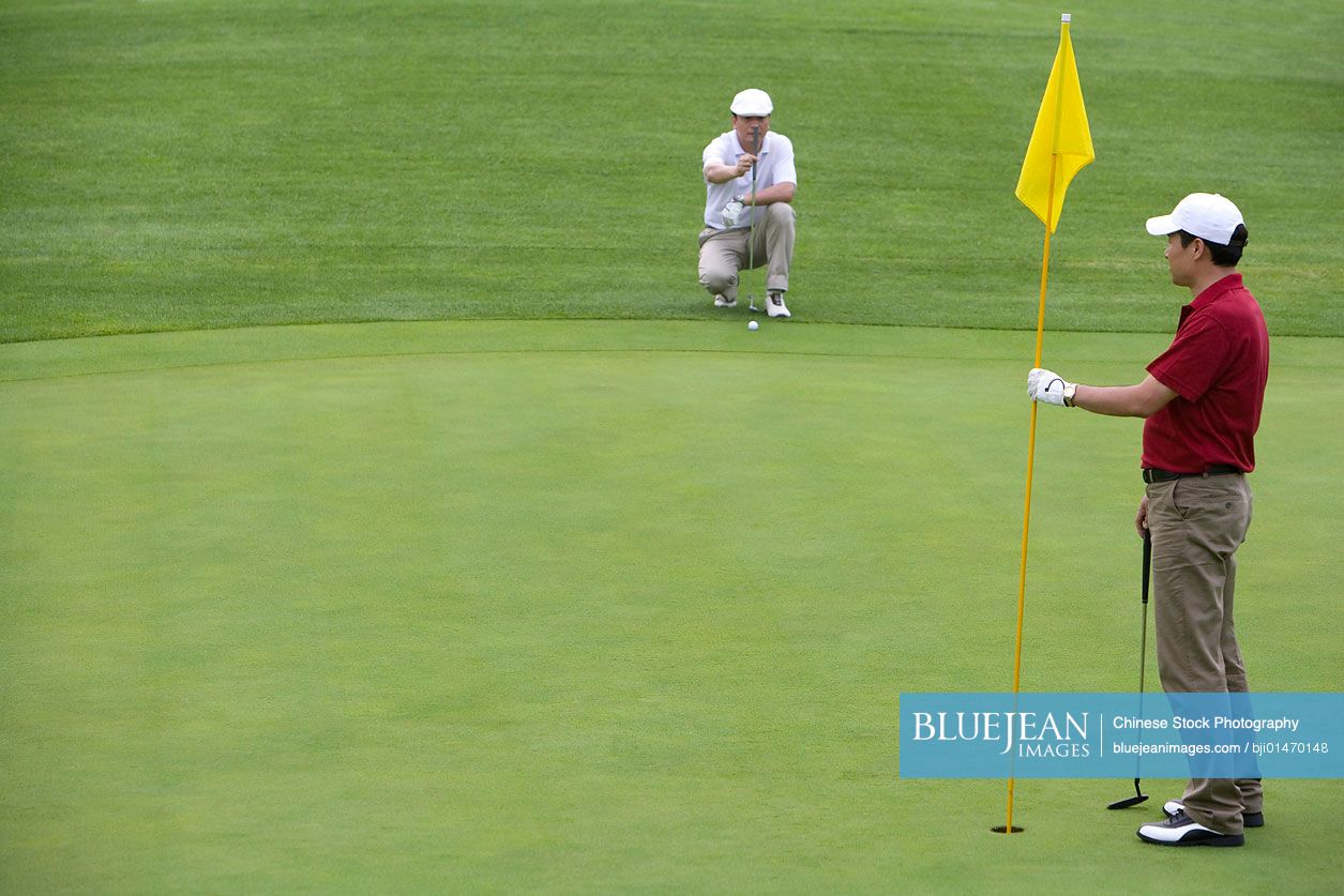 Two Chinese golfers on the green-High-res stock photo for download