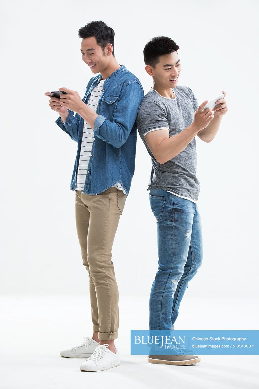 Young Chinese men playing mobile games