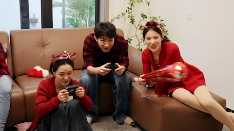 Friends playing a handheld video game together
